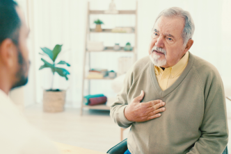 Elder patient talking about his symptoms with a physician