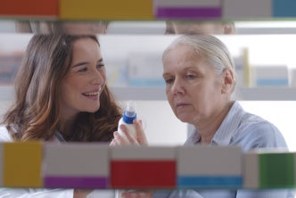 Female pharmacist discussing drug administration with a patient